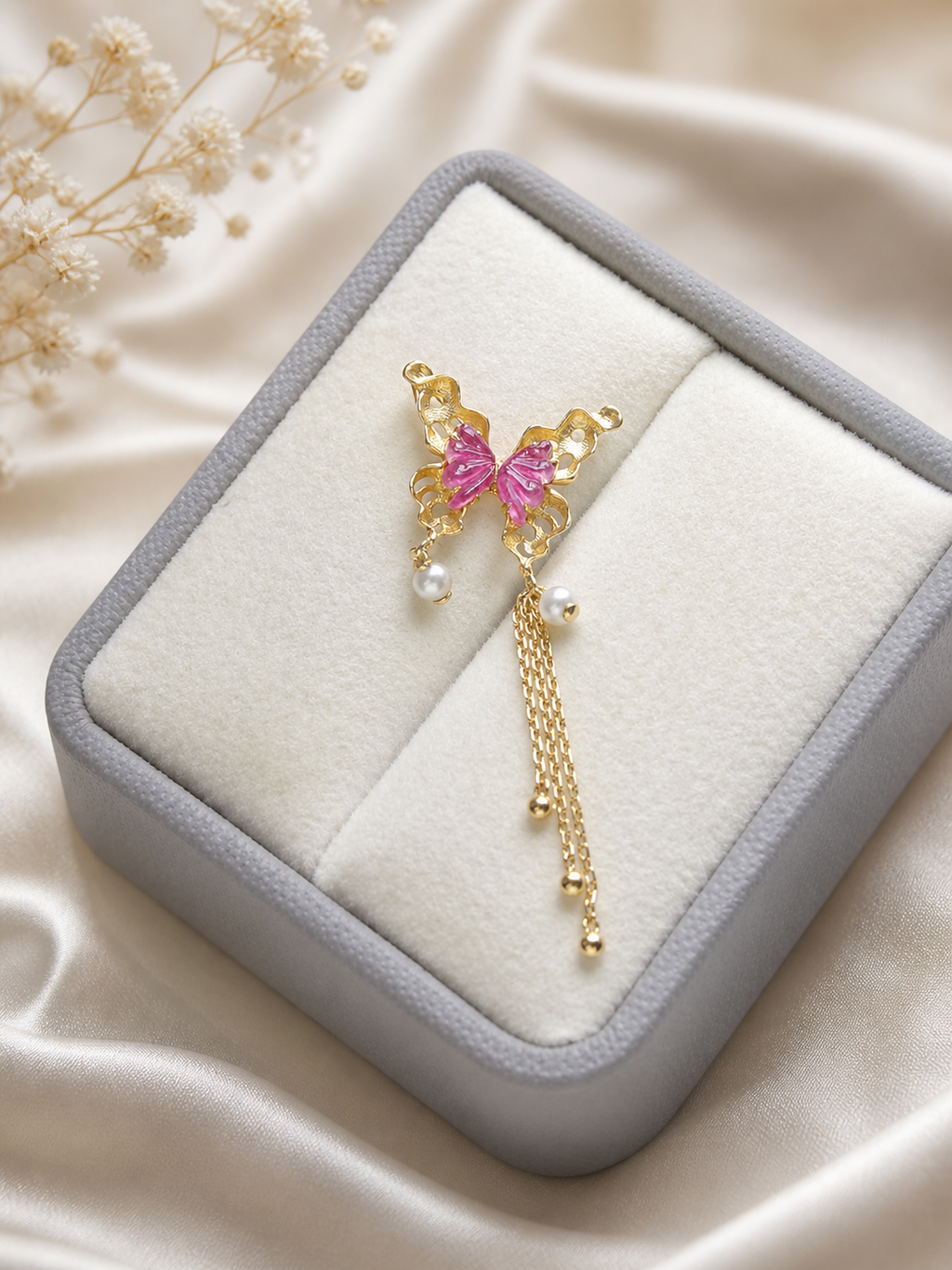 Butterfly pendant with pink tourmaline, pearl drops, and gold tassel in jewelry box