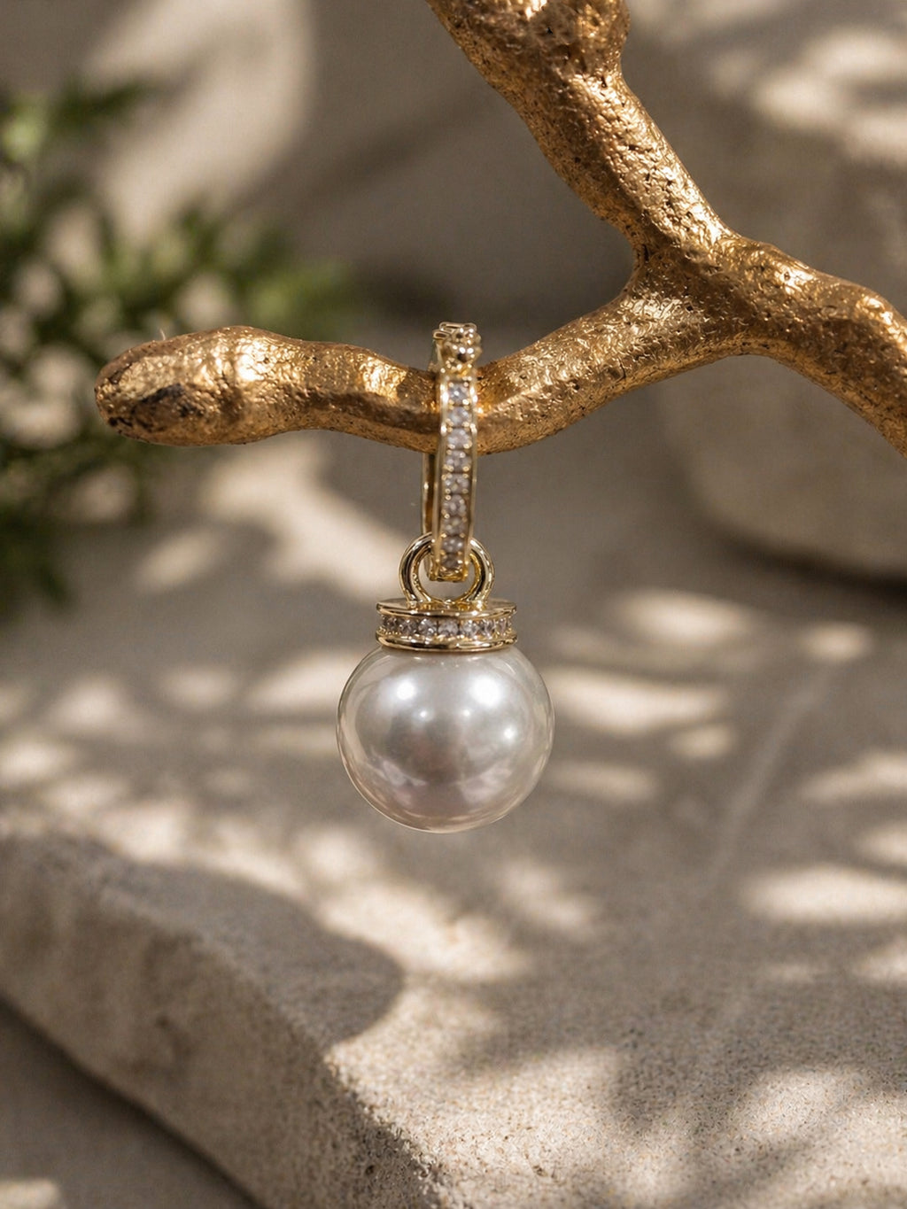 Gold South Sea pearl pendant with gemstone-set bail on a chain