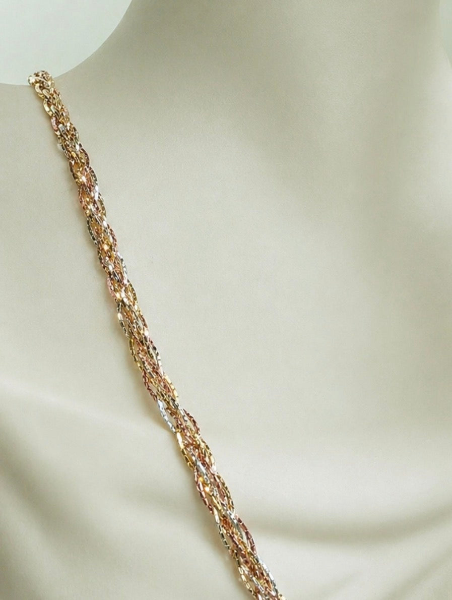 Three-tone gold braided necklace on display, straight chain close-up