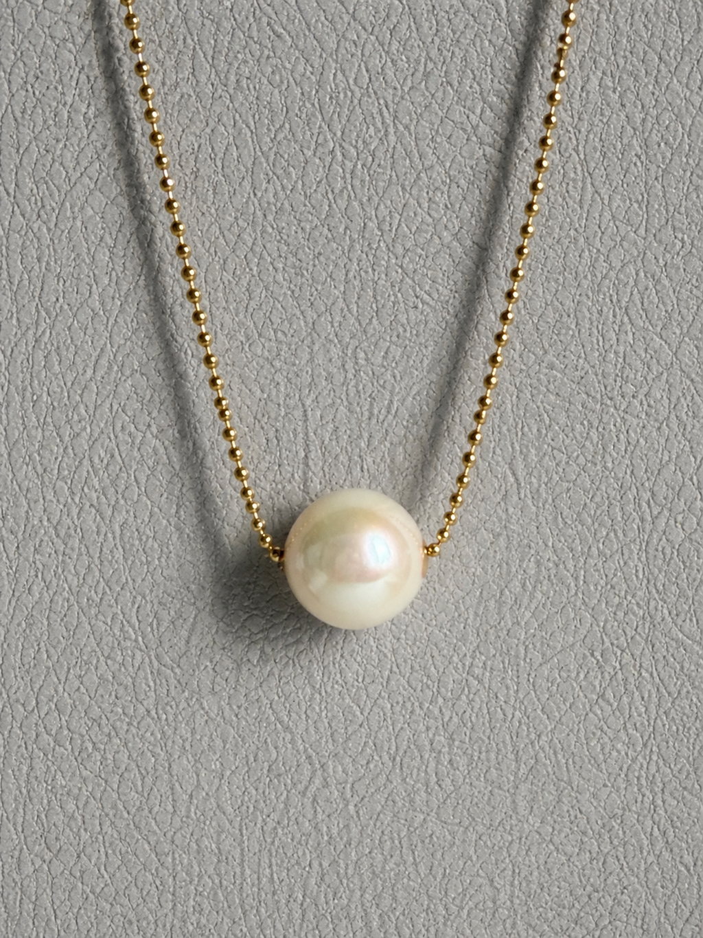 Gold-tone chain necklace with round white freshwater pearl pendant
