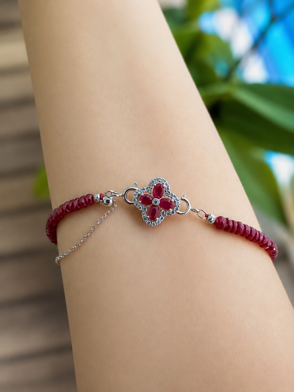 Silver ruby clover charm pendant on braided burgundy cord bracelet