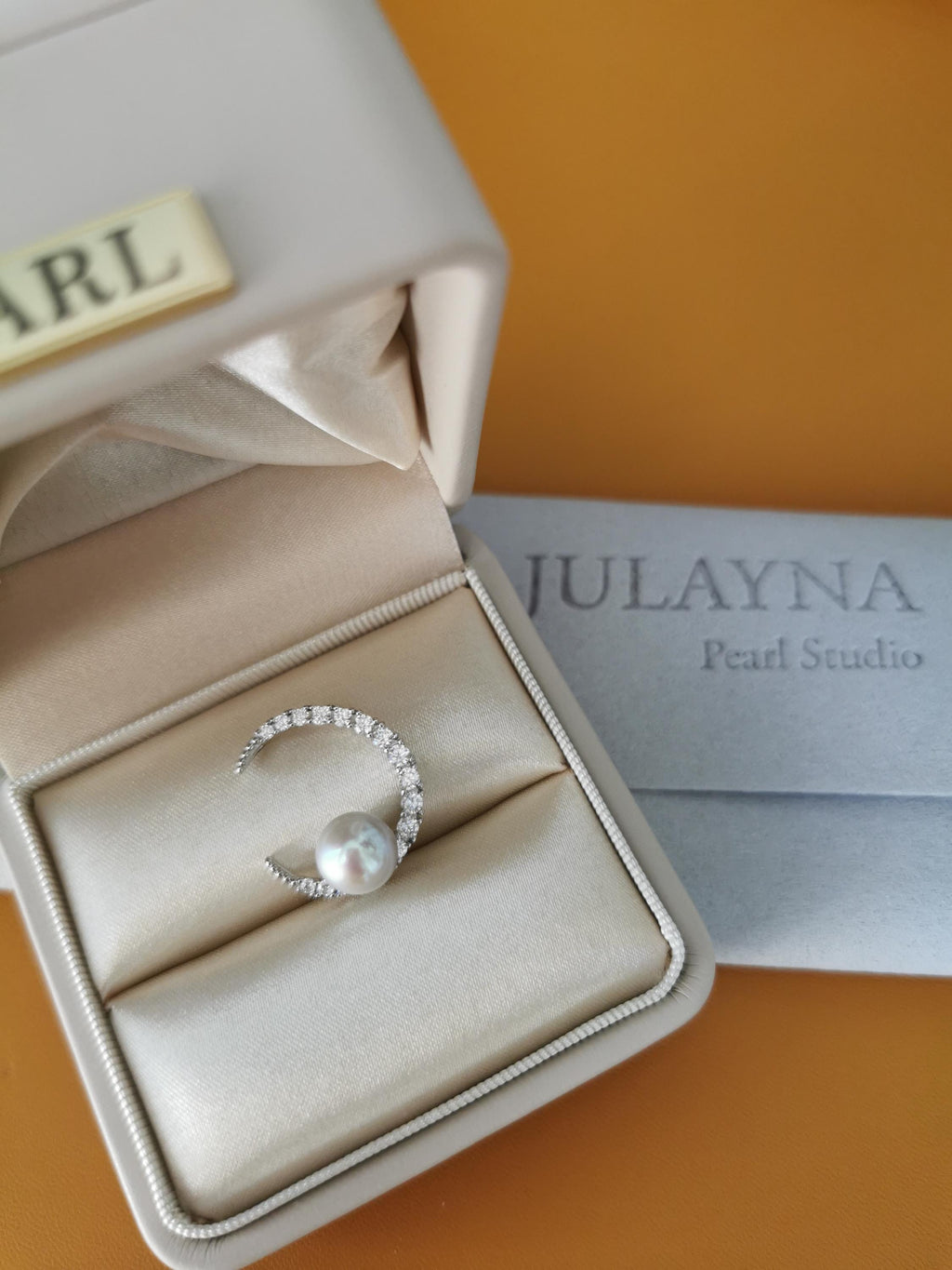 Silver crescent pearl pendant in jewelry box with round pearl centerpiece
