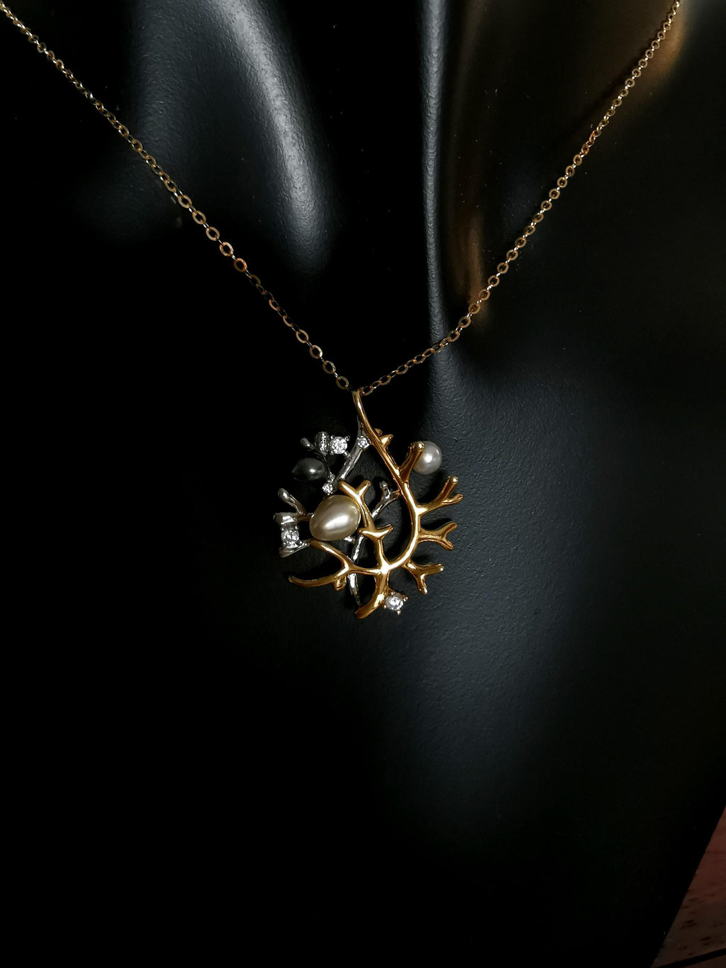 Silver necklace pendant on chain: branch design with pearls and crystal accents.