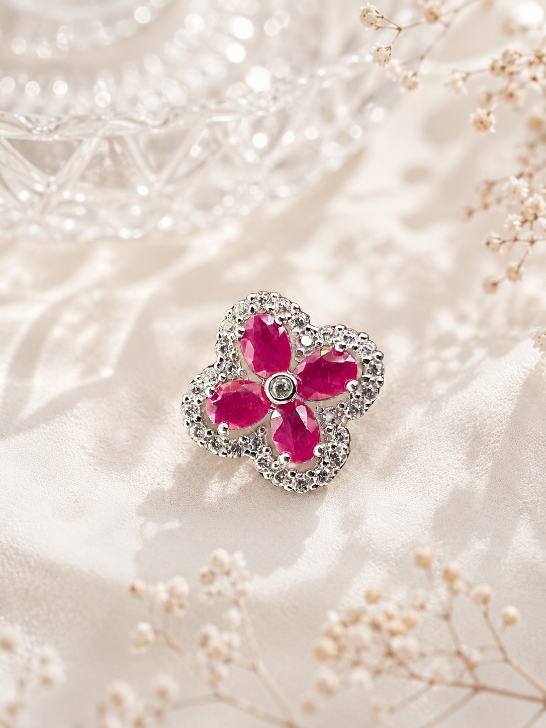 Four-leaf clover gemstone pendant in sterling silver with a pink-red center stone