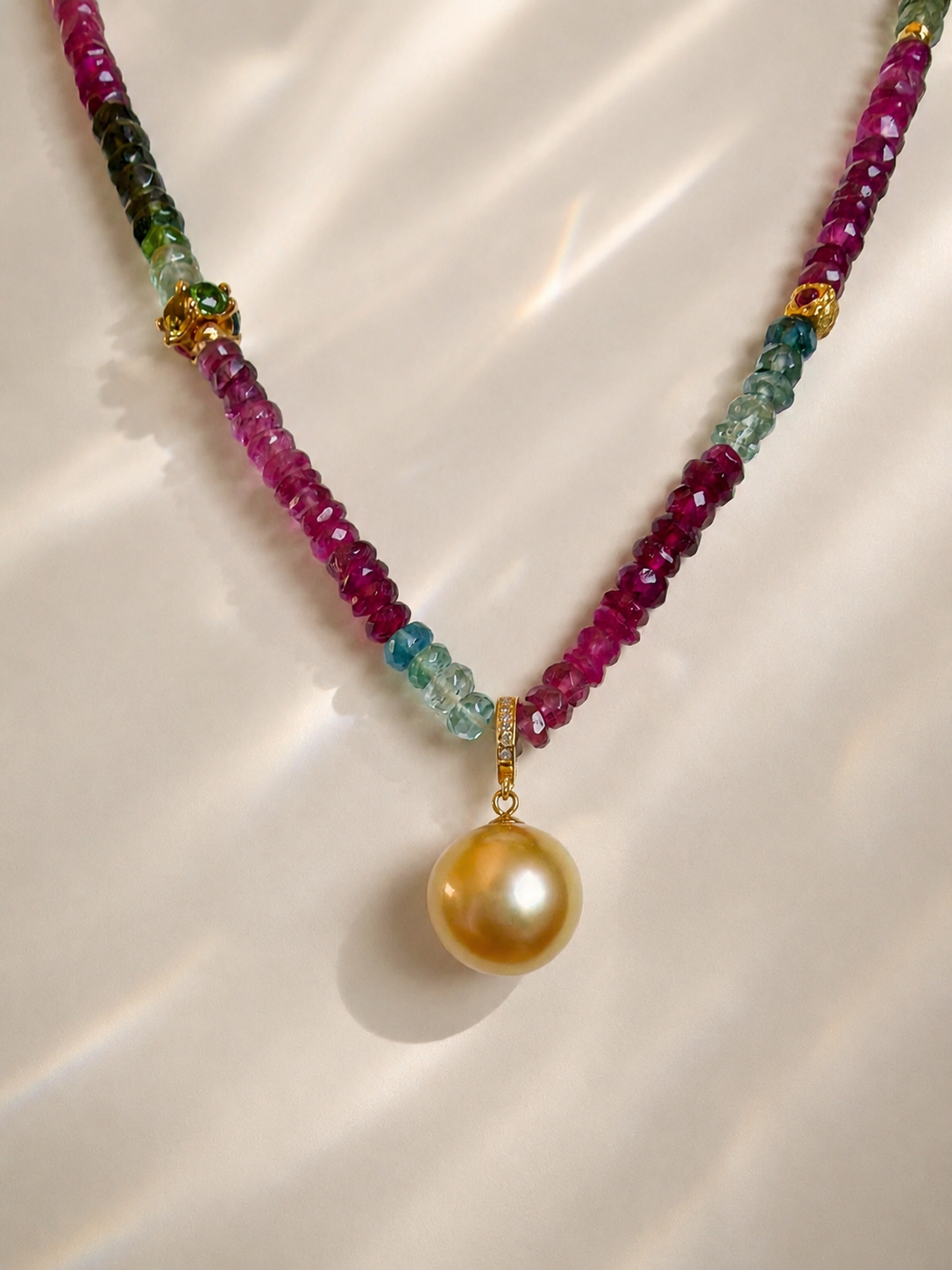 Gold pearl pendant necklace with Y-shaped strands of pink and green faceted beads