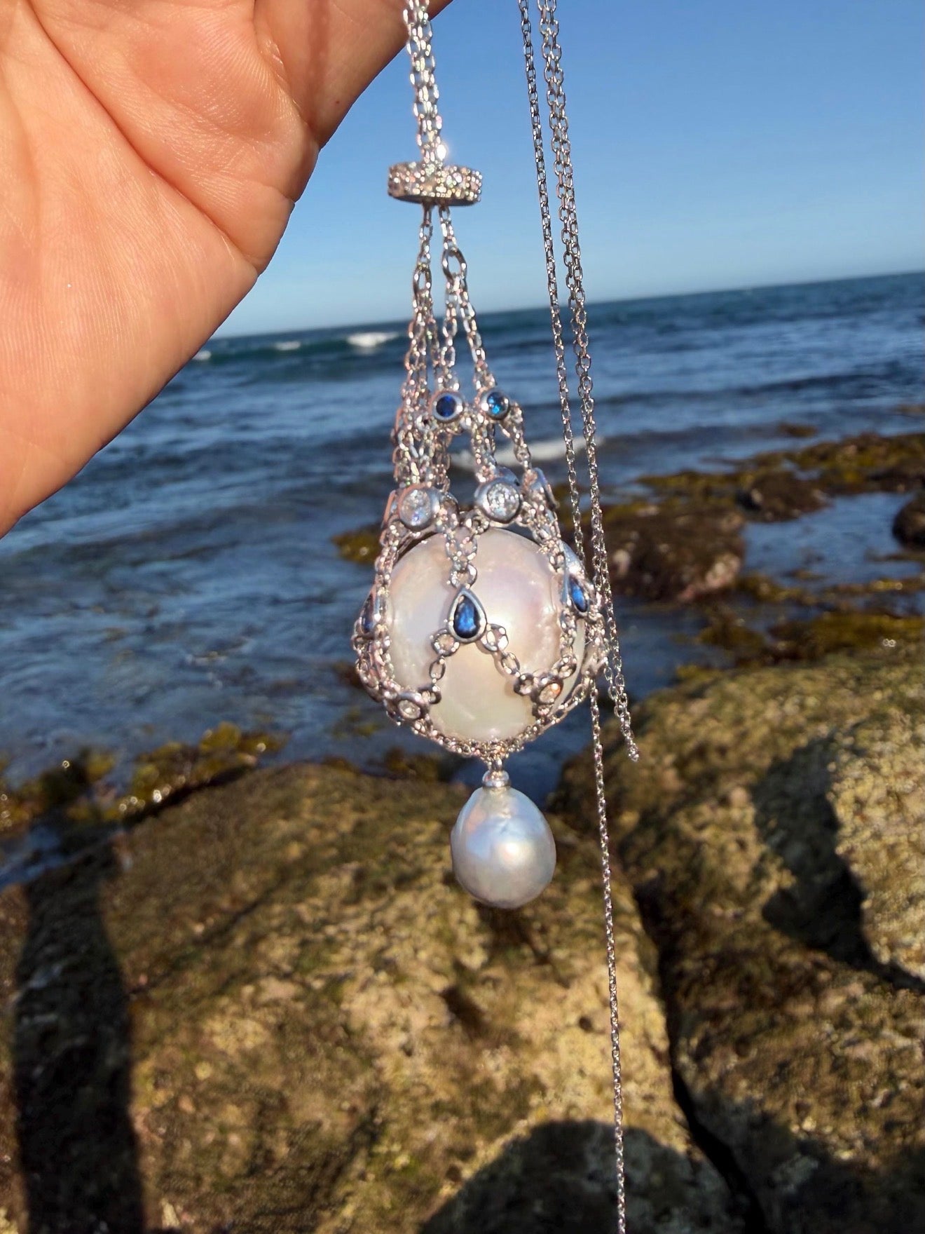 Openwork teardrop pendant necklace with blue stones and large pearl drop