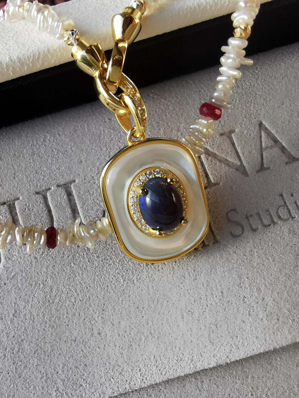 Pearl and red-bead necklace with blue opal-style pendant, gold-tone ring clasp