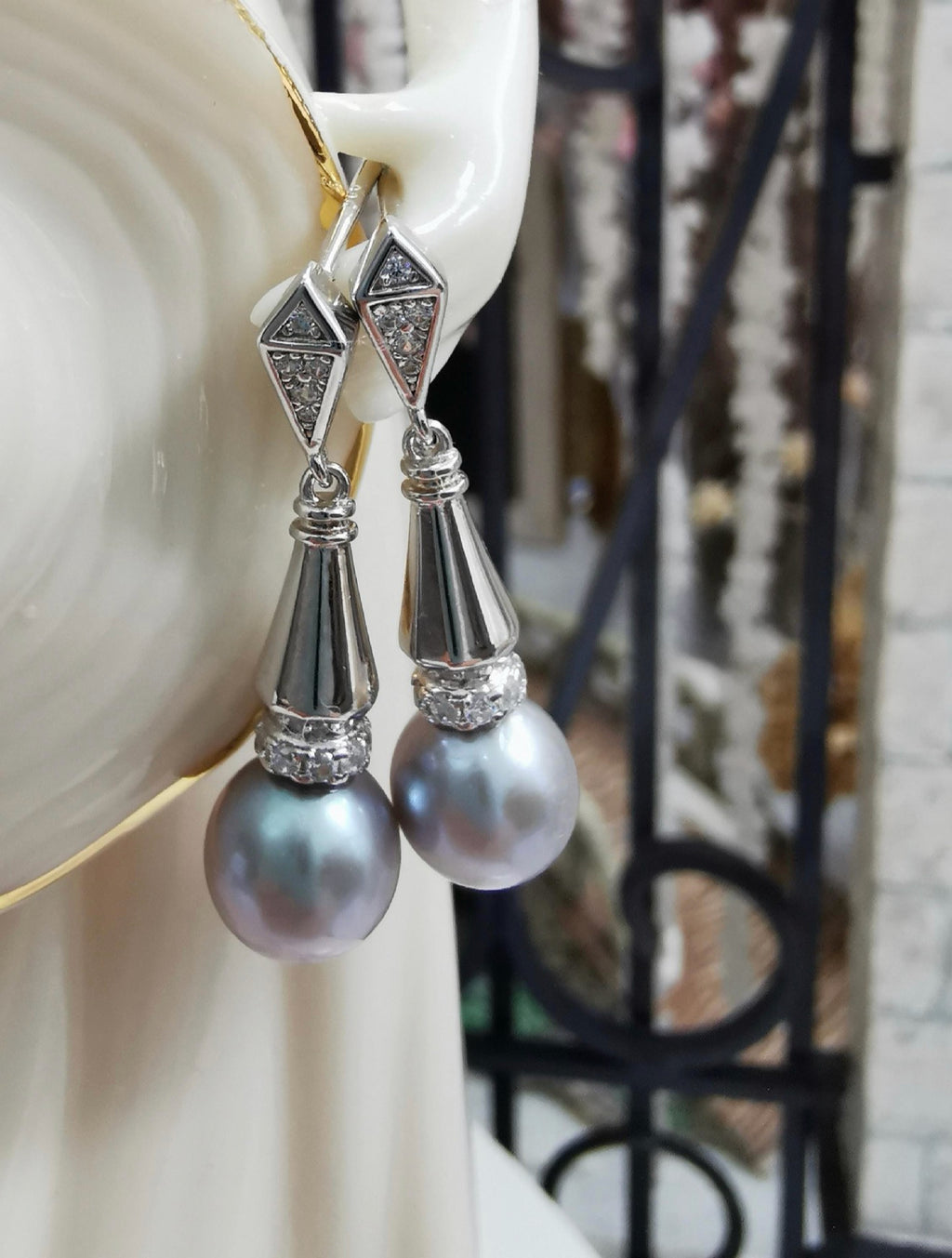 Silver-tone dangle earrings with faceted geometric top and gray teardrop pearls