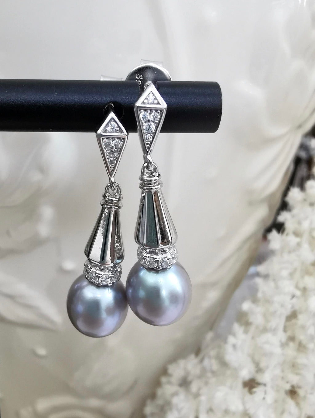 Silver-tone dangle earrings with geometric studs and gray teardrop pearls
