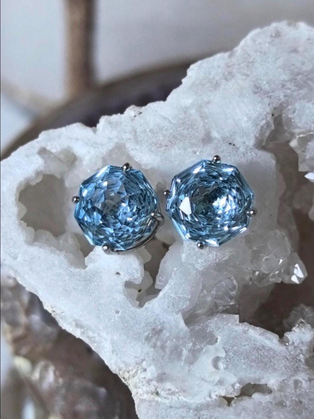 Blue topaz stud earrings on pale crystals, faceted round stones in silver settings