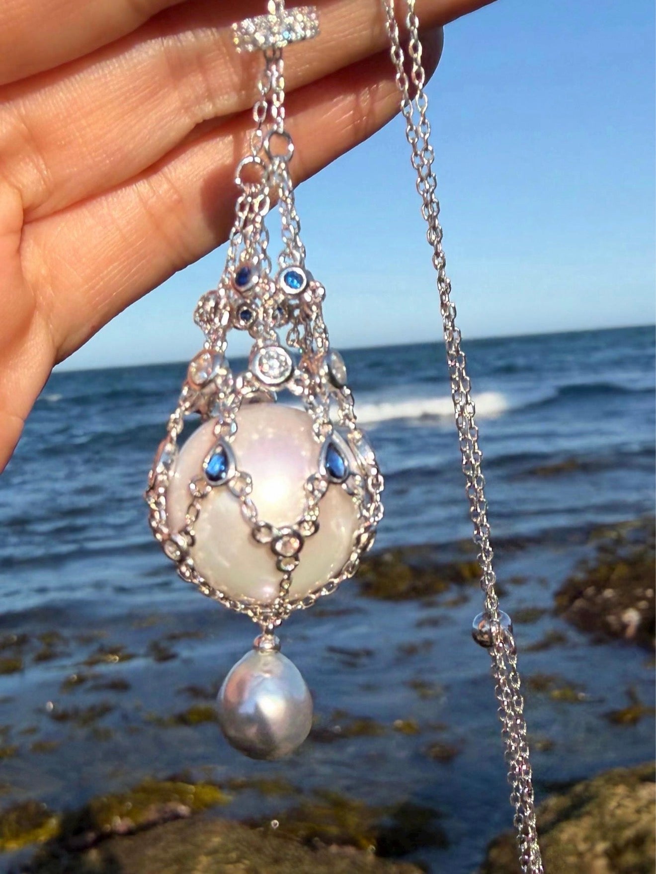 Teardrop openwork pearl pendant necklace with blue stones and hanging pearl