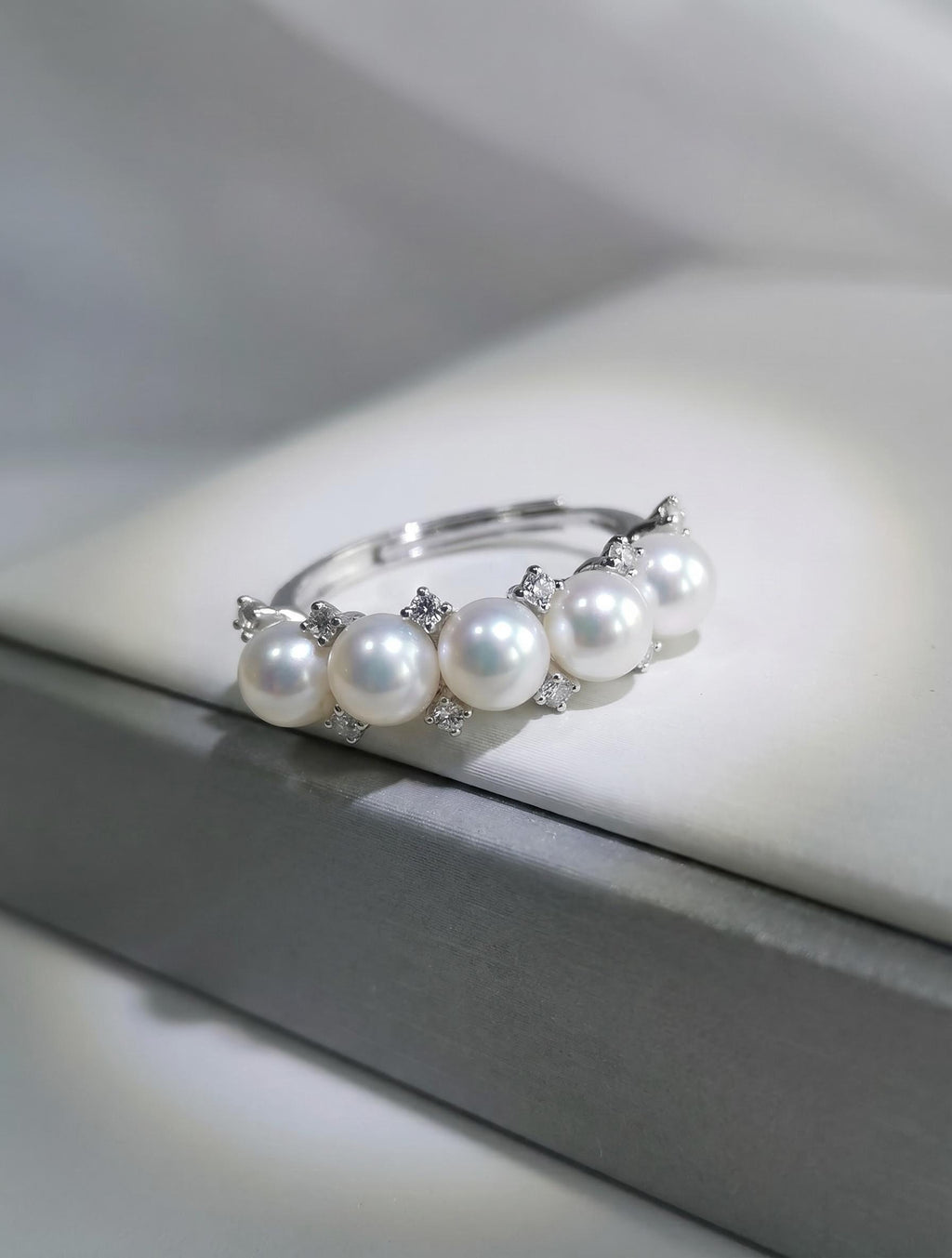 Adjustable silver pearl ring with five white freshwater pearls and crystal details