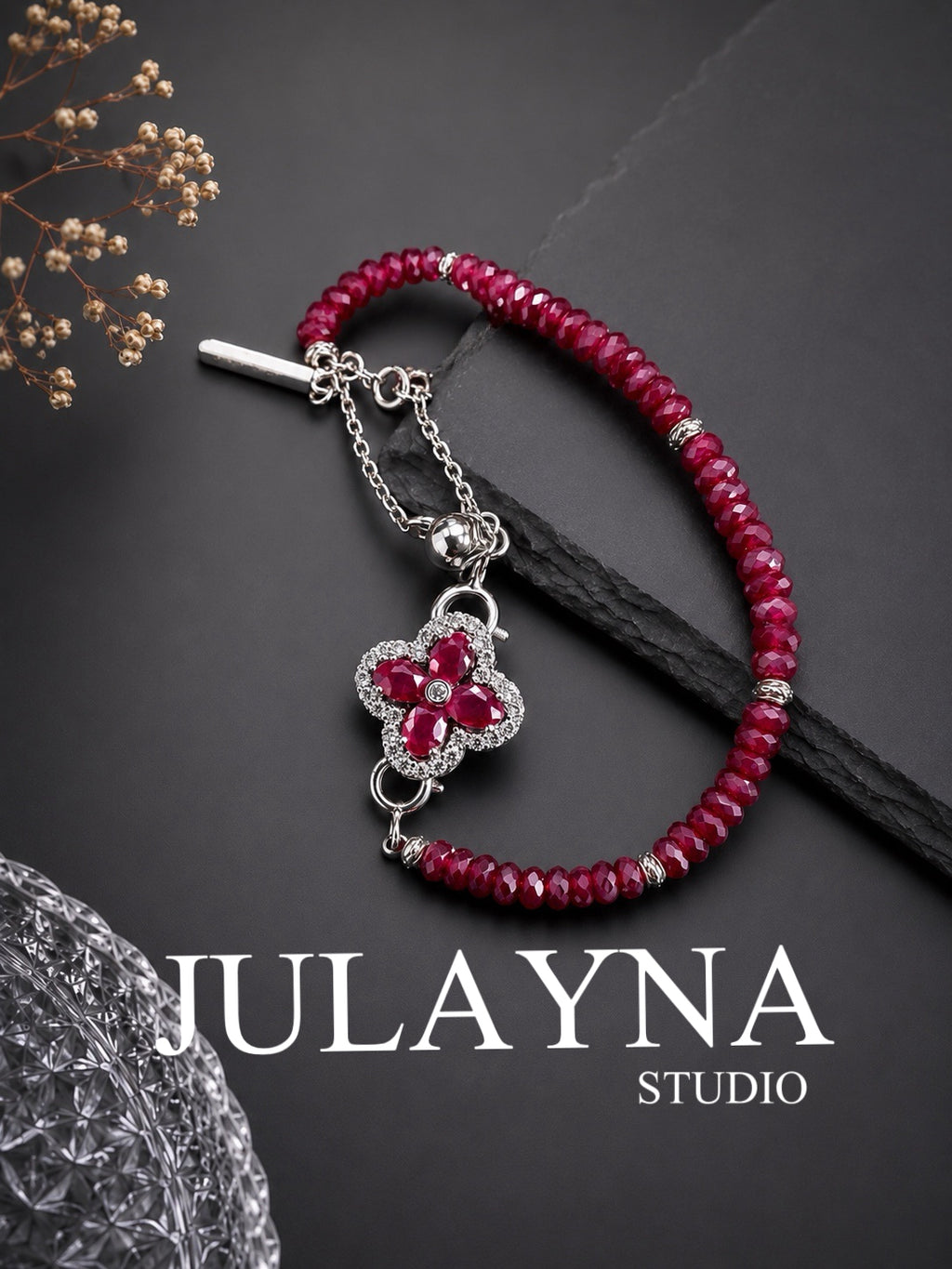 Ruby clover charm bracelet with silver clasp on braided burgundy cord
