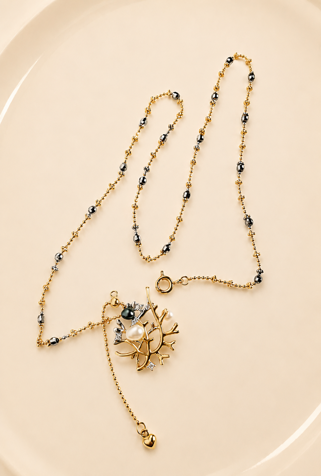 Layered beaded necklace with small pearl-like accents and dangling star charm
