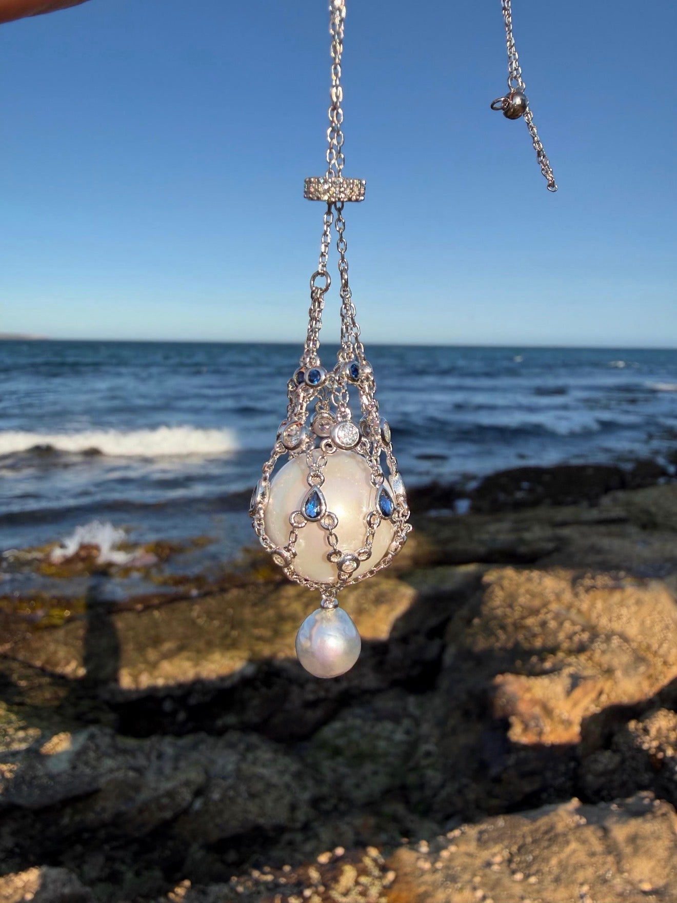 Silver tone teardrop openwork pendant necklace with blue stones and pearl drop