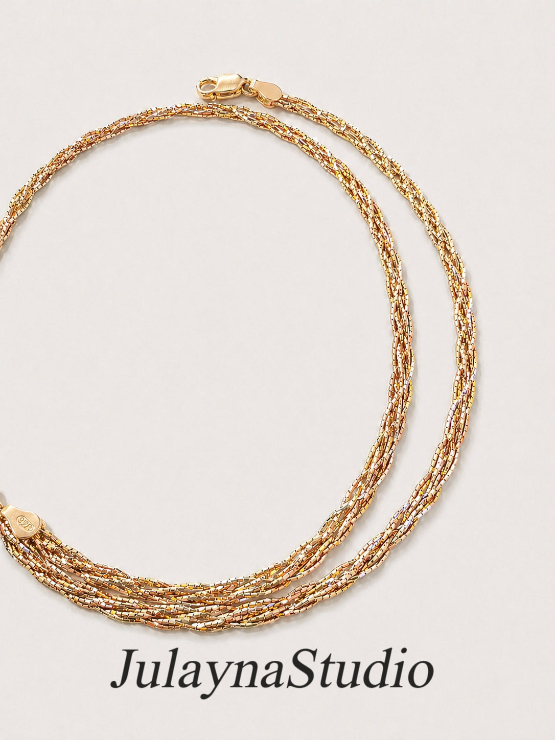 Three-tone braided gold multi-strand necklace with clasp and twisted links
