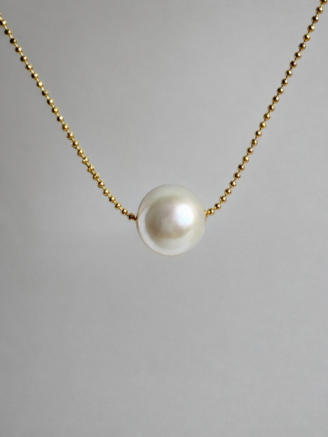 Gold-tone chain necklace with teardrop white freshwater pearl pendant