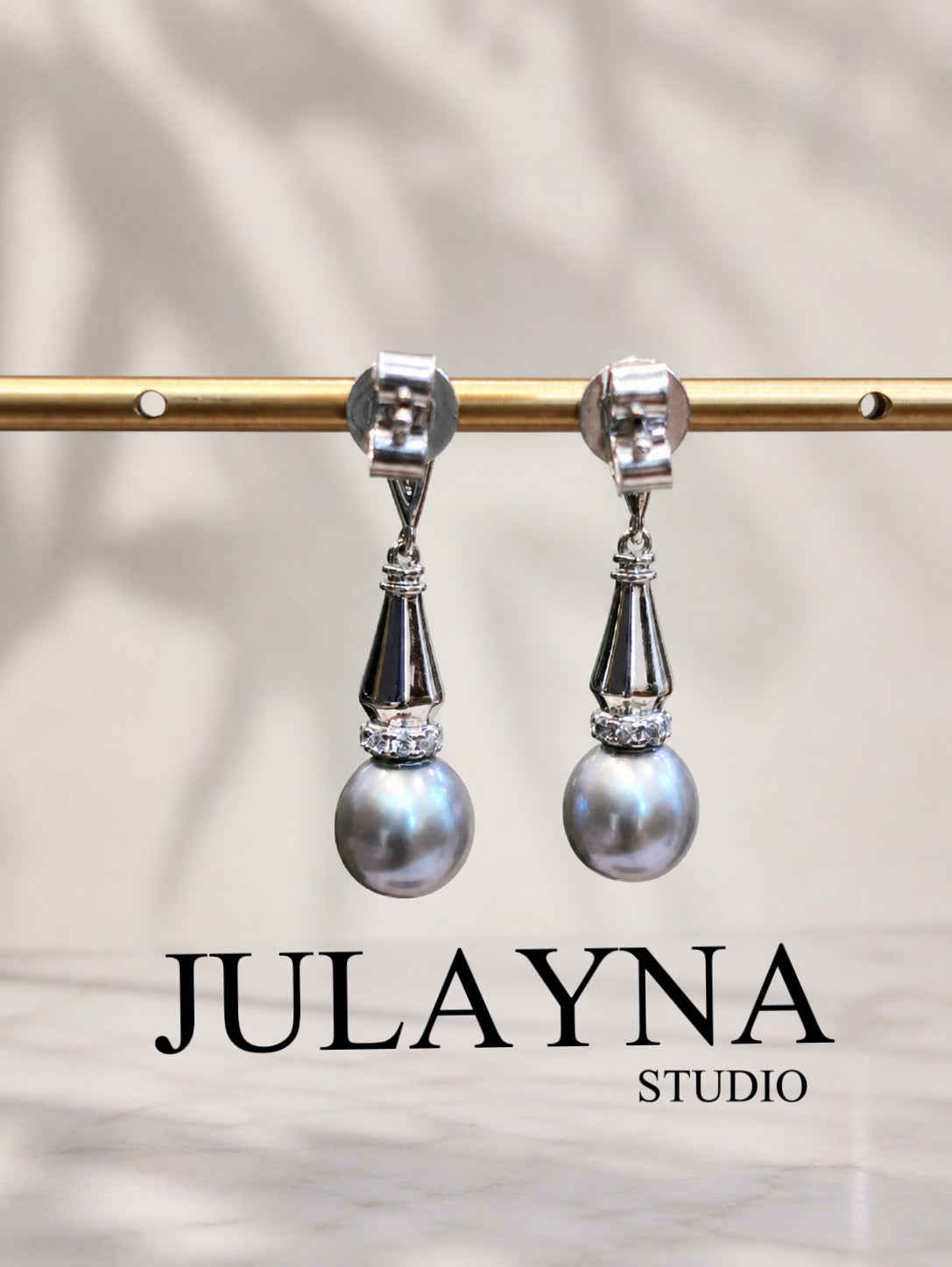 Silver-tone dangle earrings with faceted connectors and gray drop pearls
