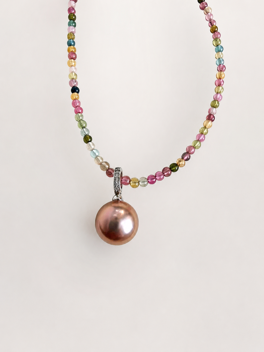Rainbow beaded necklace with multicolor stones and a pink round pearl pendant