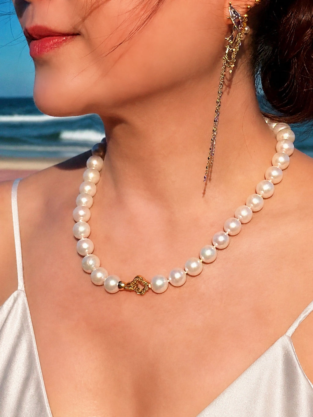 Pearl bead necklace with gold-tone clover centerpiece and white all-nacre pearls