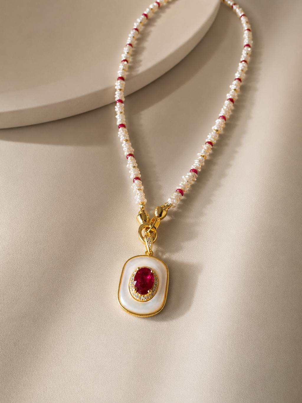 Beaded pendant necklace with white and red beads and mother-of-pearl ruby pendant