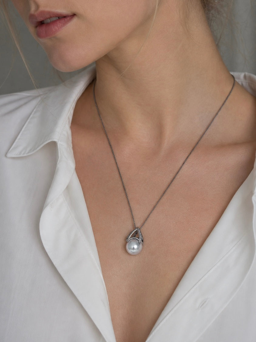 Pear-shaped freshwater pearl pendant with metal loop and pavé trim on chain