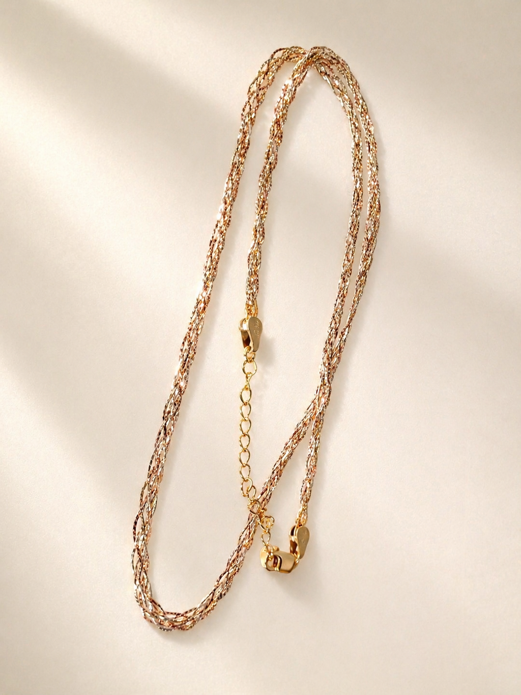Three-tone gold braided necklace set, two braided strands with gold clasp detail