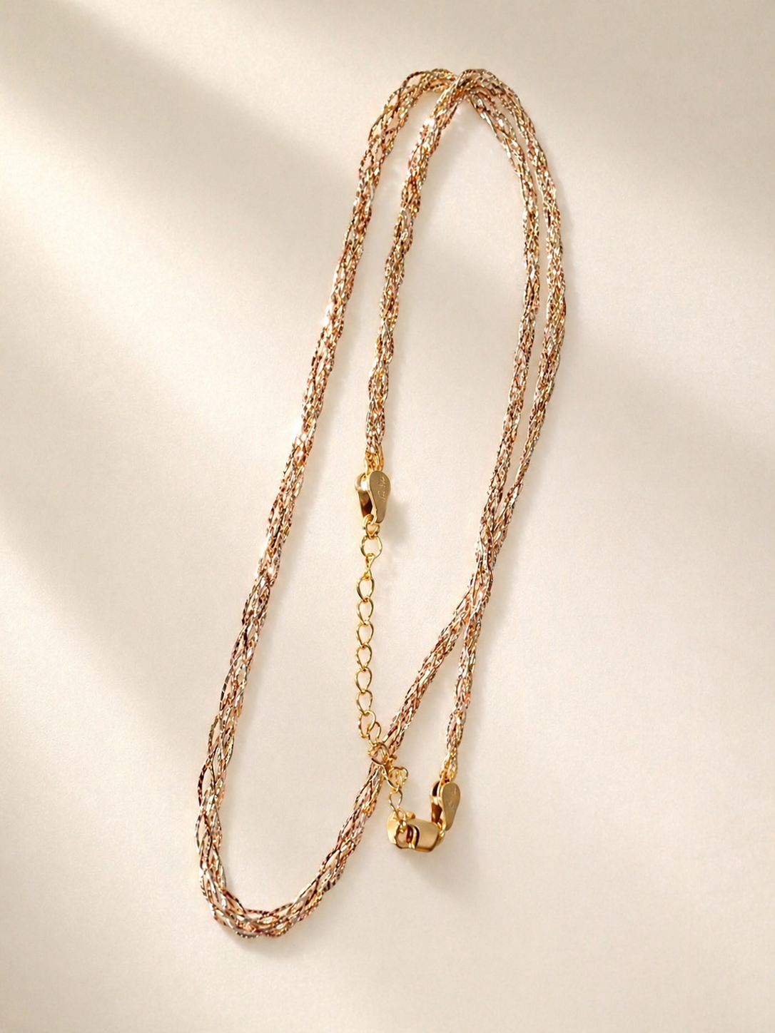 Three-tone gold braided necklace set, two braided strands with gold clasp detail