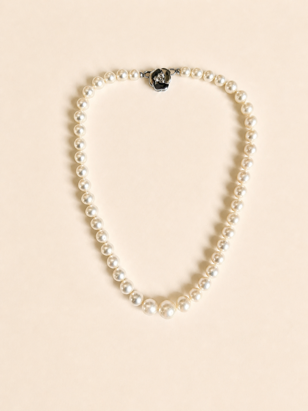 South Sea pearl necklace with round white pearls and a central black accent bead
