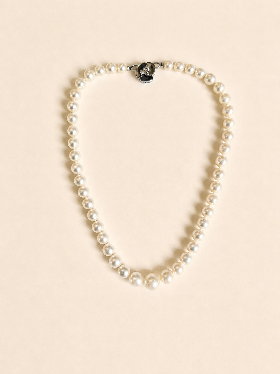 South Sea pearl necklace with round white pearls and a central black accent bead