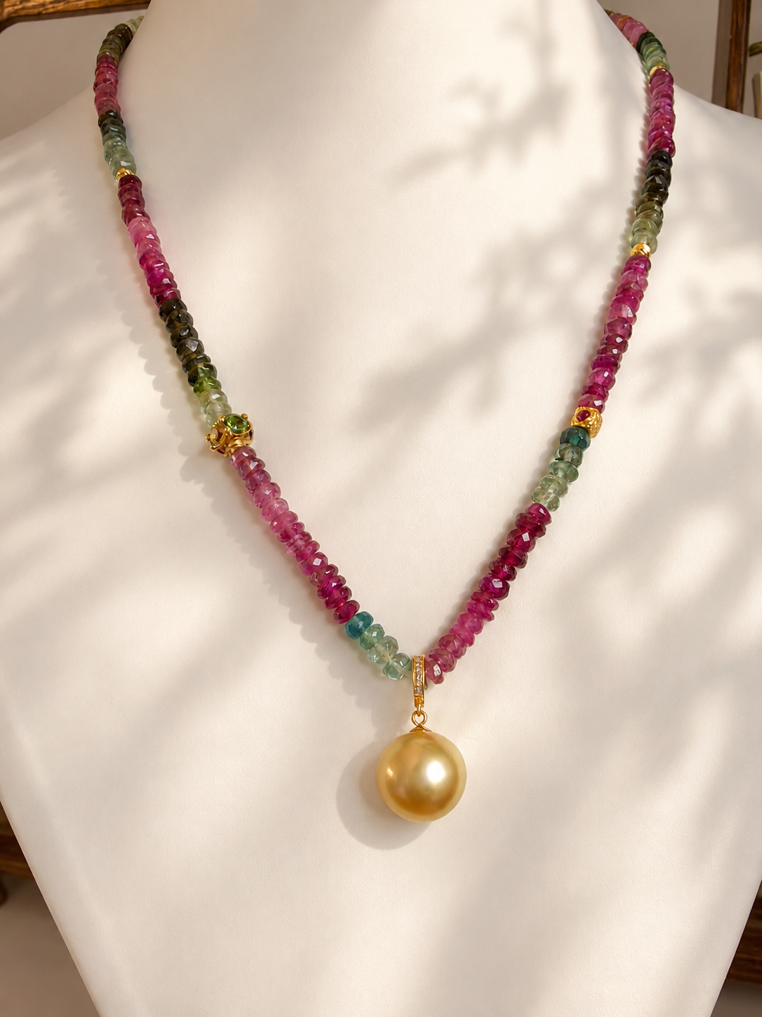 Gold pearl pendant necklace with pink and green gemstone beaded strands