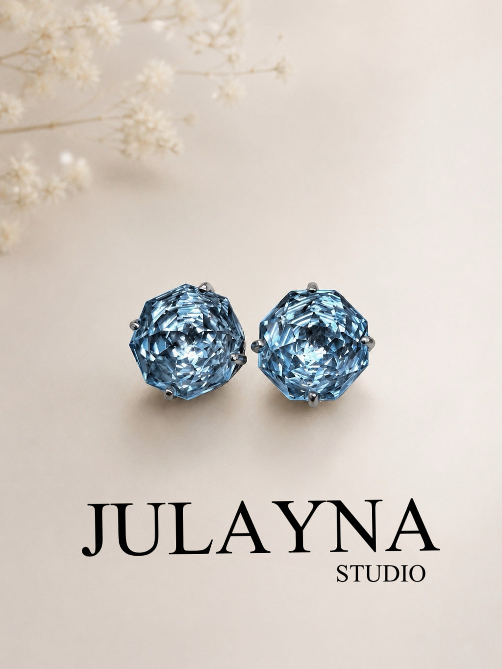 Blue topaz stud earrings with faceted round stones in silver bezel settings