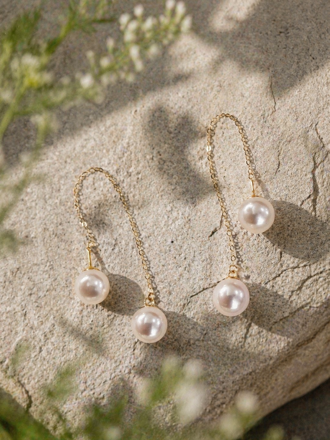 Long threader pearl earrings with gold-tone chains and clustered dangling pearls