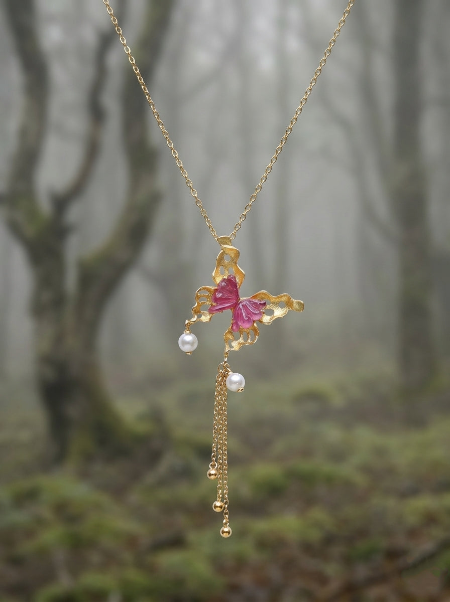 Gold butterfly pendant with pink tourmaline and pearl tassels on a thin chain