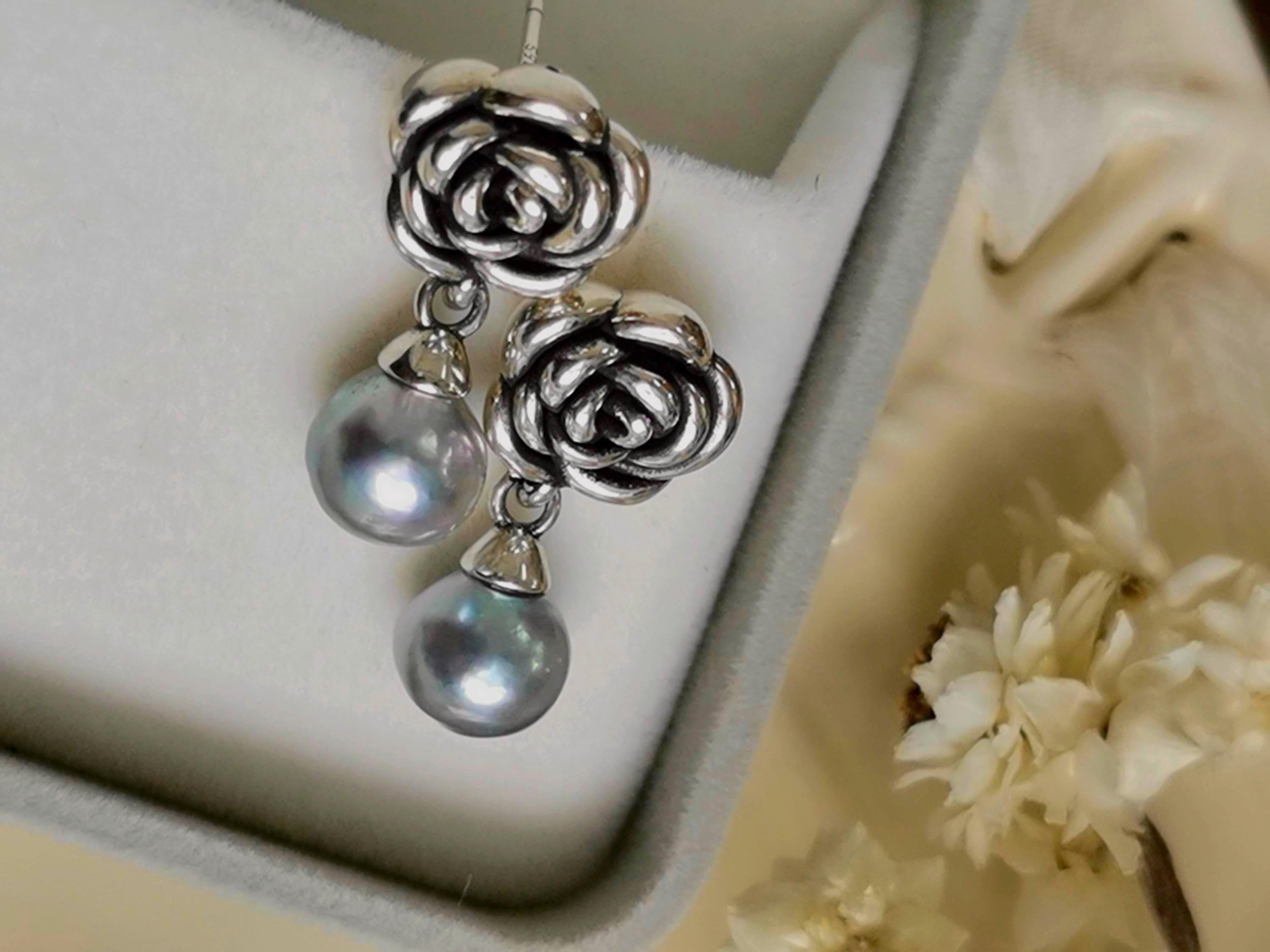 Silver rose earrings with two iridescent pearl drops, shown in open box