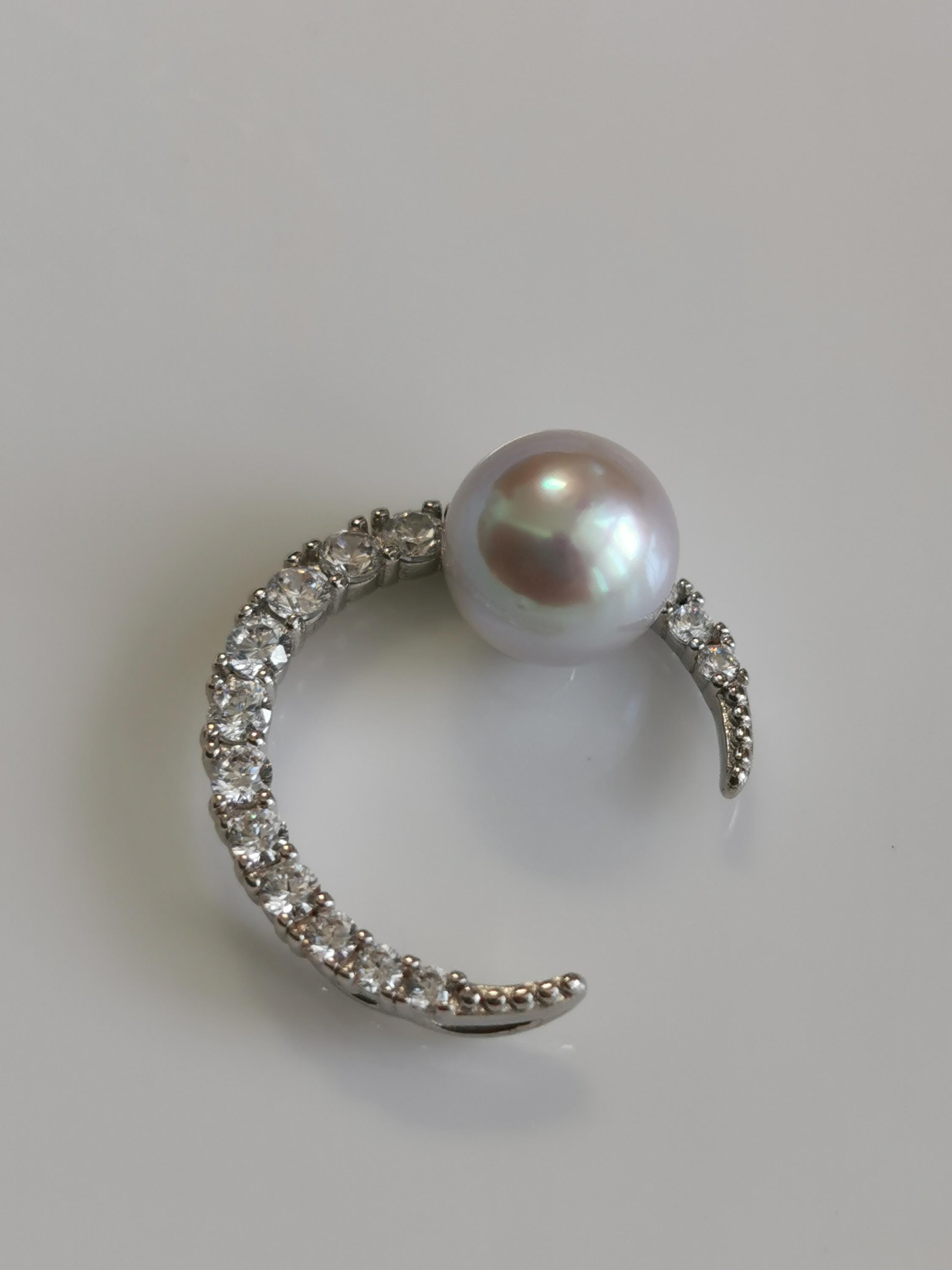 Silver crescent pendant with round pearl and pavé stone detailing