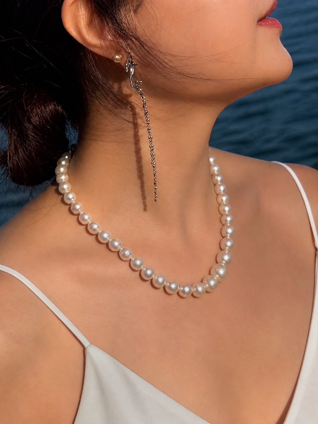 South Sea pearl necklace with round white pearls and a silver chain on the neckline