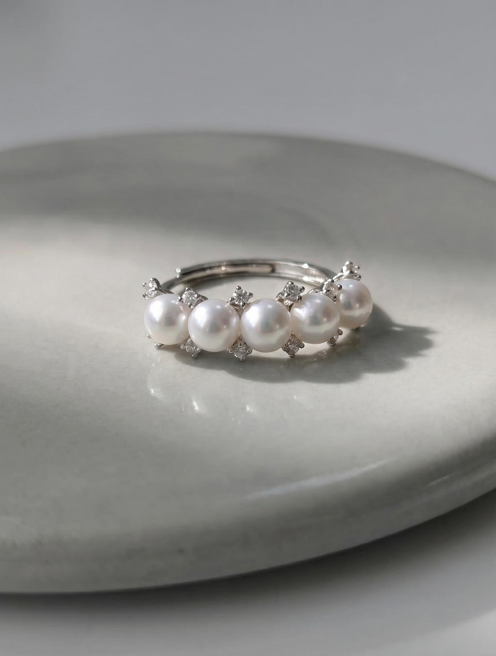 Adjustable silver pearl ring featuring five white freshwater pearls