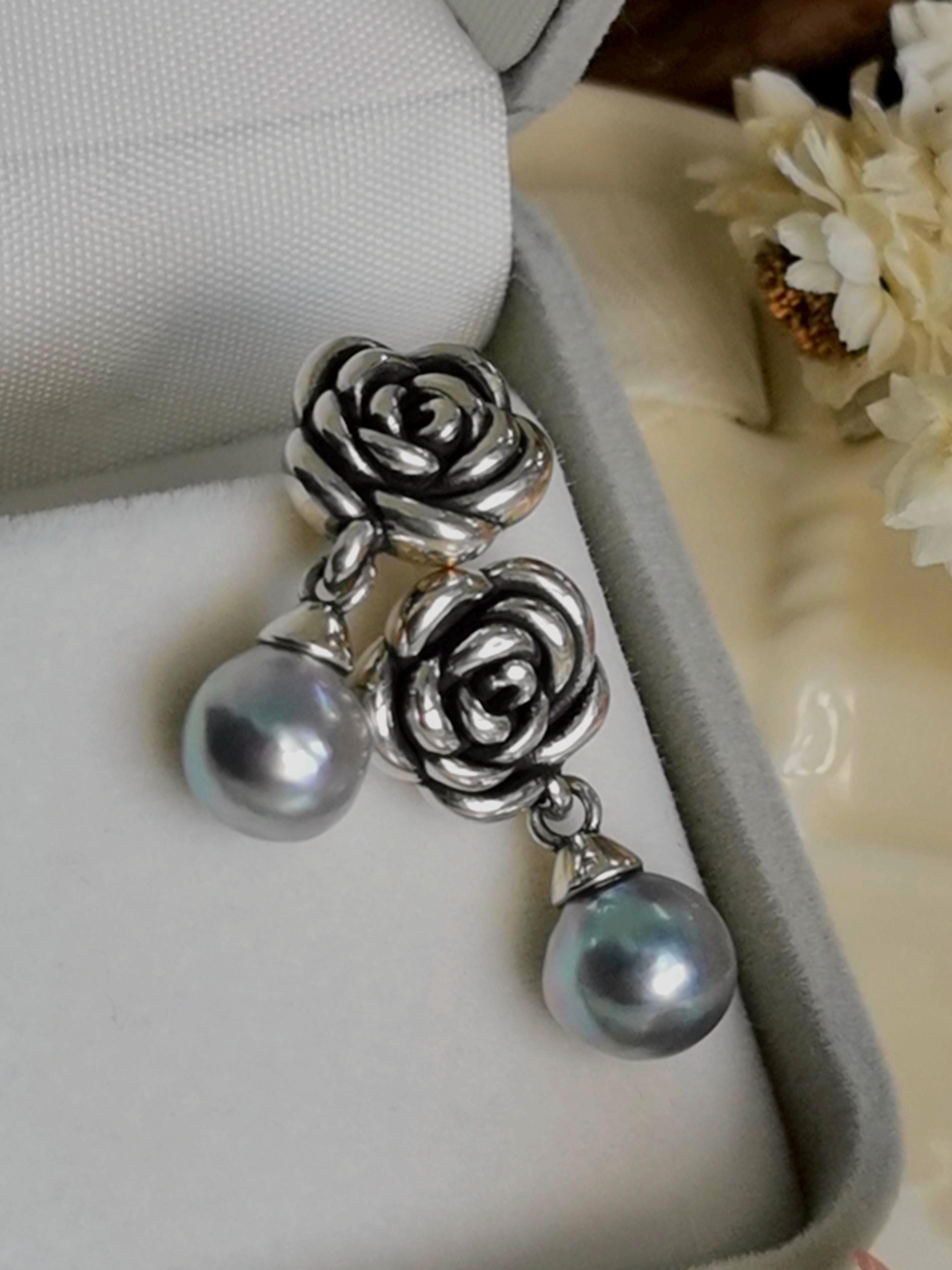 Silver rose dangle earrings with round pearl drops in a jewelry box