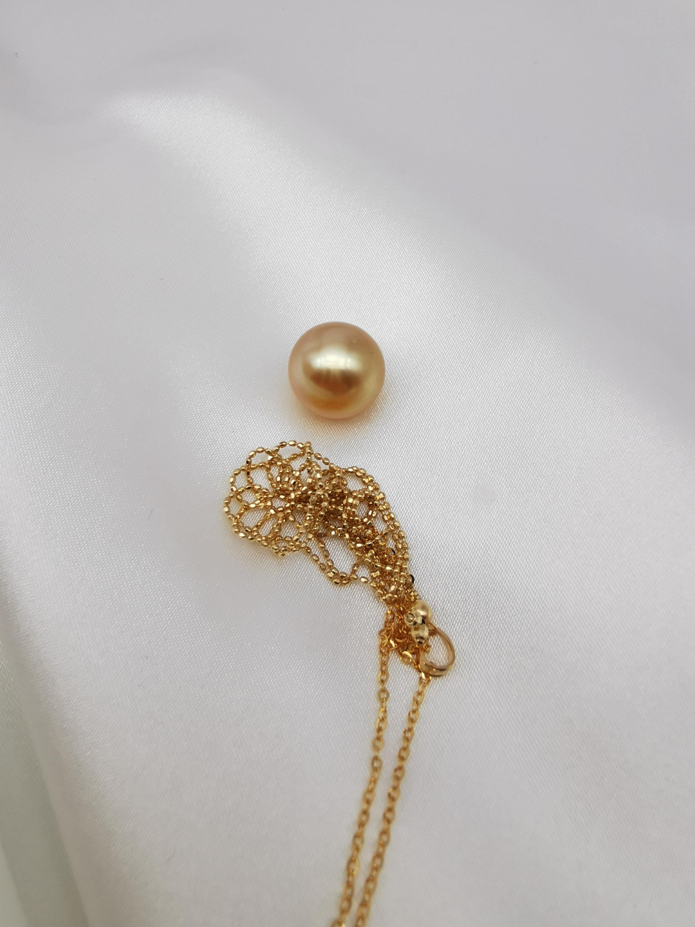 18K solid gold net pouch pendant with golden pearl on gold chain close-up