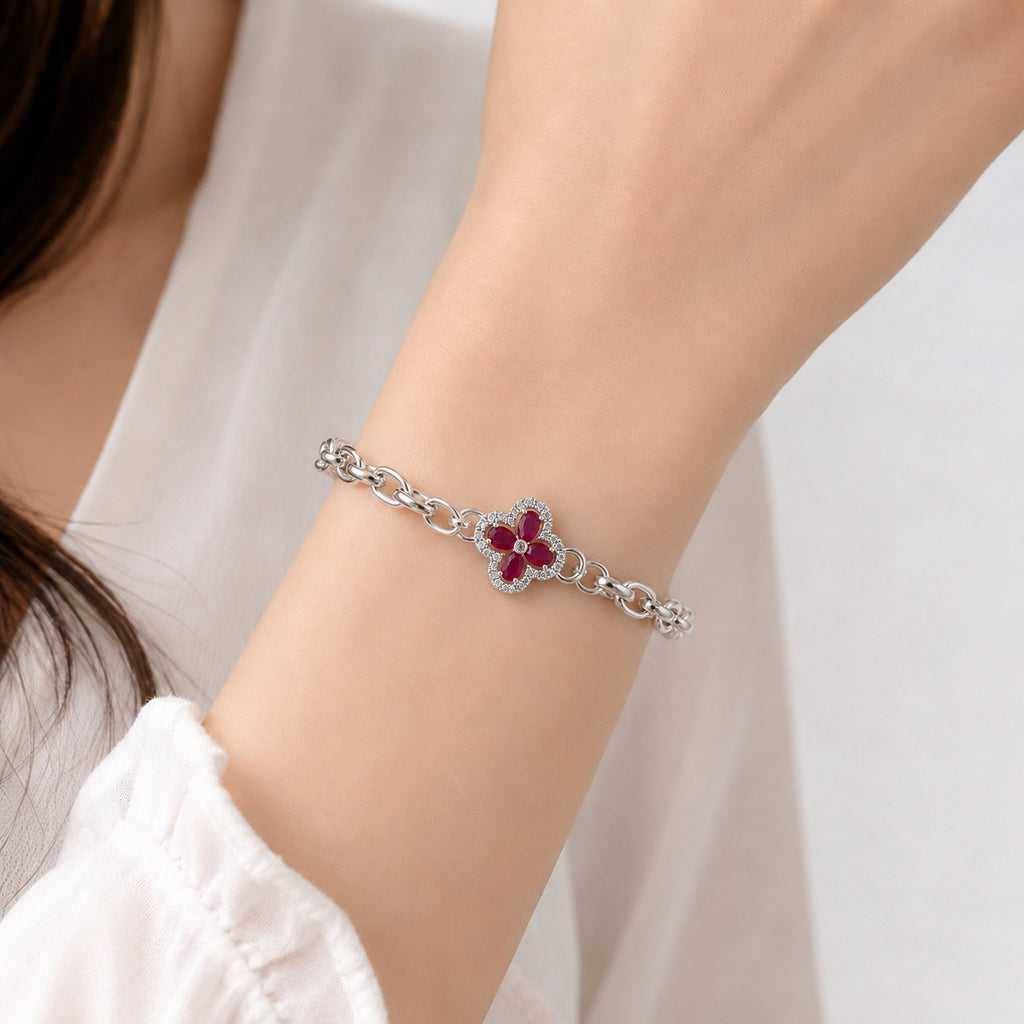 Four-leaf clover gemstone pendant on a silver chain bracelet