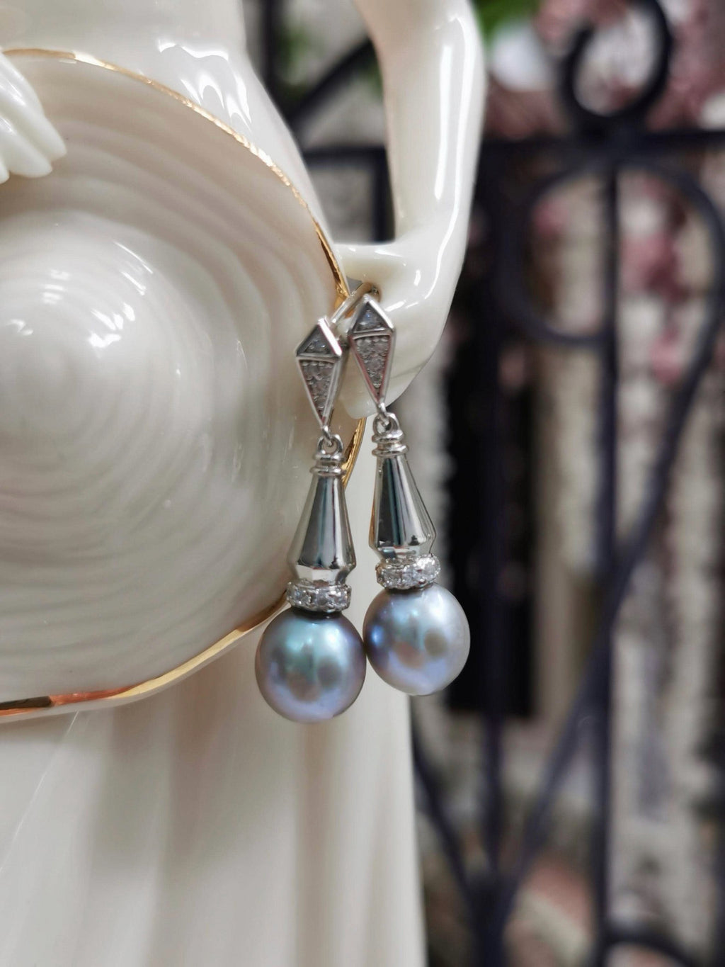 Silver-tone dangle earrings with faceted geometric tops and gray teardrop pearls