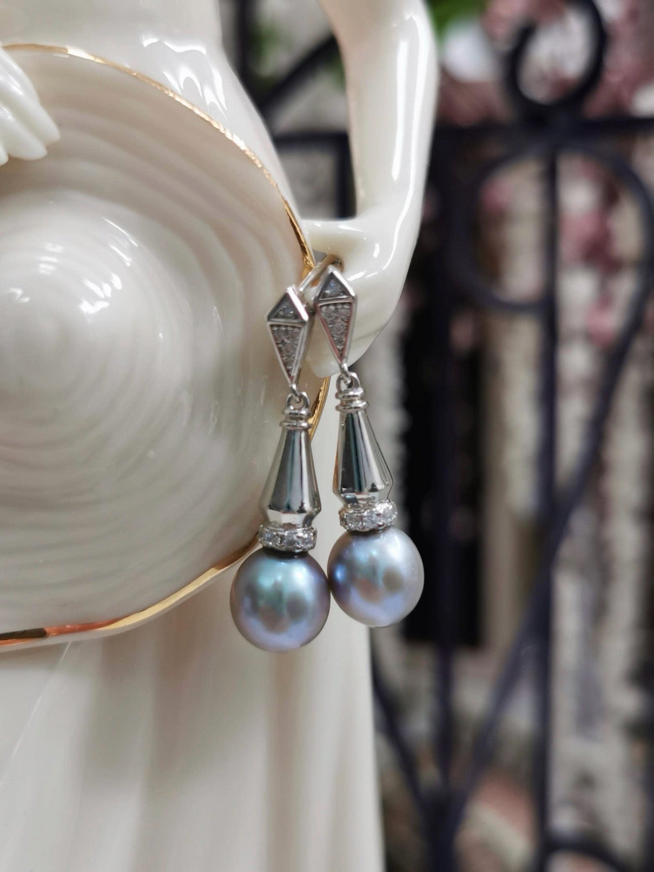 Silver-tone dangle earrings with faceted geometric tops and gray teardrop pearls