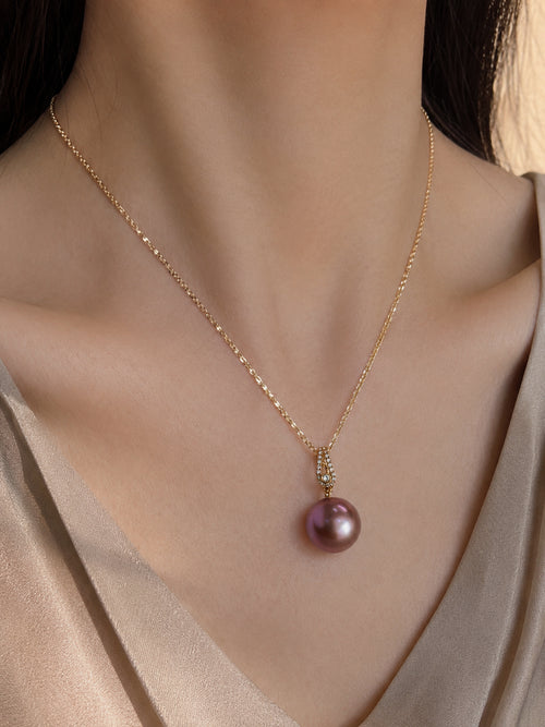 Gold pendant necklace with purple pearl drop and small diamond-set bail