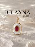 Gold-tone mother-of-pearl pendant with ruby oval stone and small hoop bail