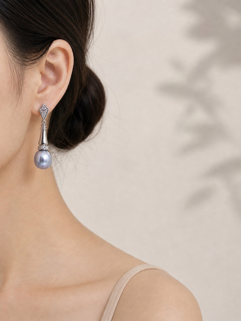 Silver-tone dangle earrings with gray teardrop pearls and faceted geometric tops