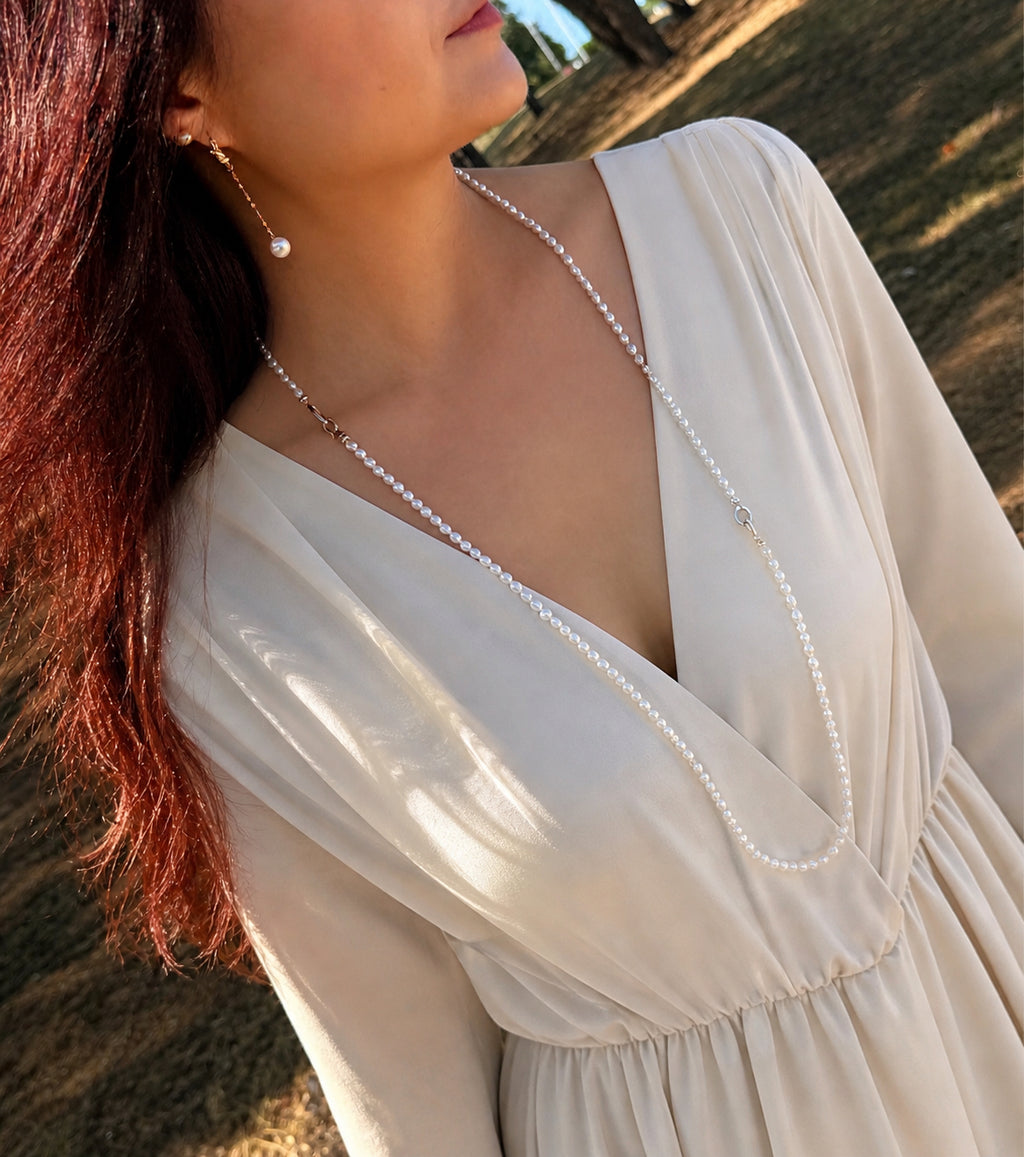 Keshi pearl beaded necklace worn on a V-neck dress, layered at the collar