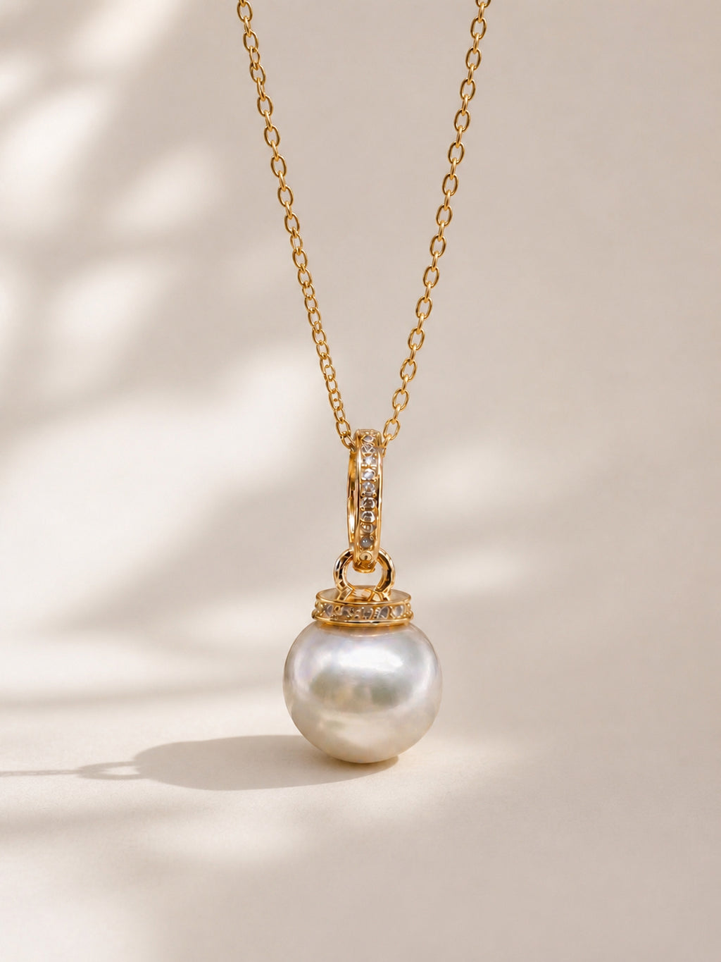 Gold pendant necklace with round South Sea pearl and pavé gemstone bail