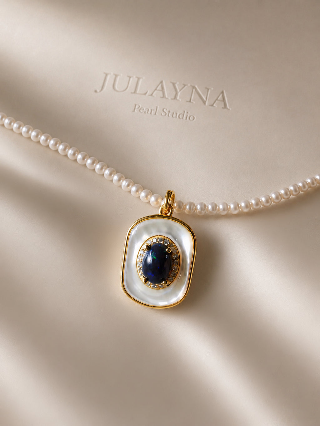Pearl necklace with blue opal-style pendant, gold-tone frame and pearl strand