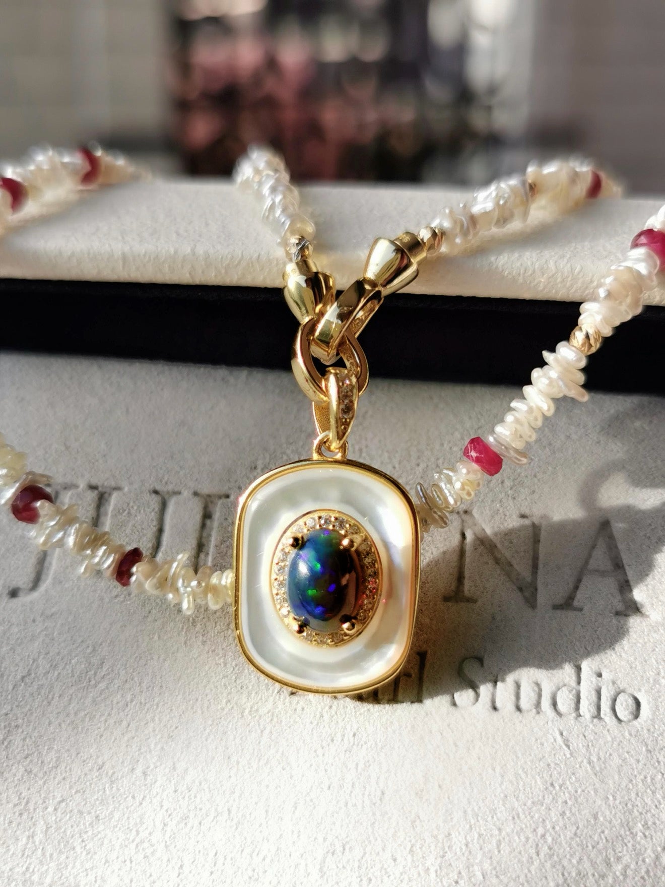 Pearl and red-bead necklace with blue opal-style pendant, gold-tone bail
